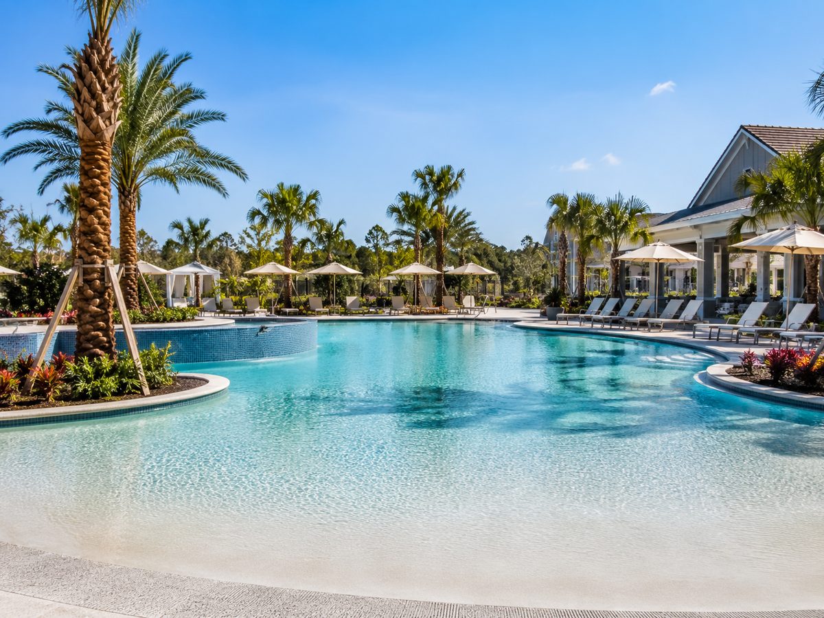 Resort style swimming pool with a zero entry edge and shaded seating